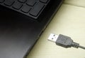 USB cable plugging in to laptop