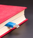 Usb cable sticks out from red book Royalty Free Stock Photo