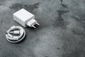 Usb cable with usb wall charger plug, on gray stone table background, with copy space for text Royalty Free Stock Photo