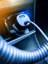 USB car charger connected to the car cigarette lighter Royalty Free Stock Photo