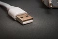 USB charger cable on black surface closeup often used for charging smartphone or tablet Royalty Free Stock Photo