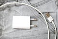 Usb charger, wire and adapter plug in grey jeans pocket, dont forget charger at home Royalty Free Stock Photo