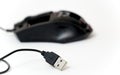 USB connection of a black out of order computer mouse on white background,focus on usb. Royalty Free Stock Photo