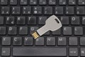 USB flash drive on a black keyboard. Key Royalty Free Stock Photo