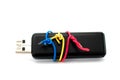 USB Flash Drive closeup wrapped with colorful wires on white background