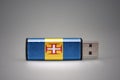 Usb flash drive with the national flag of madeira on gray background.