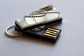 USB flash drive with pearlescent case and metallic chain Royalty Free Stock Photo