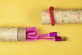 Usb lightning pink data cable in a cardboard tube close-up on yellow isolated, space for text Royalty Free Stock Photo