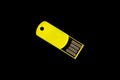 USB memory stick - Yellow flash drive on an isolated black background Royalty Free Stock Photo