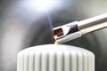 Tesla lighter ignites candle wick Royalty Free Stock Photo