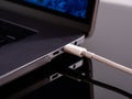 USB Type C cable being connected to the laptop computer. Fast charging concept. Power up a laptop. Charging computer battery. Stay