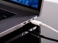 USB Type C cable being connected to the laptop computer. Fast charging concept. Power up a laptop. Charging computer battery. Stay