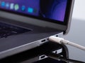 USB Type C cable being connected to the laptop computer. Fast charging concept. Power up a laptop. Charging computer battery. Stay