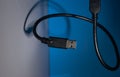 USB wire on blue and gray backgrounds. Close-up Royalty Free Stock Photo