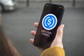 USD coin USDC cryptocurrency symbol, logo. Business and financial concept. Hand with smartphone, screen with crypto icon