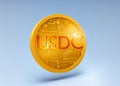 usdc cryptocurrency coin. gold coin on a blue background close-up. stablecoin 3d image