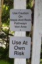 Use caution on steps and rocks sign Royalty Free Stock Photo