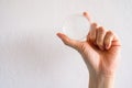 Close up of someone hand holding a clear transparent Crystal ball.