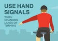 Use hand signals when changing lanes or turning. Close-up back view of a cyclist showing left turn gesture while cycling.