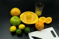 use juicer different citrus fruits, squeezed orange and cutting board with knife Royalty Free Stock Photo