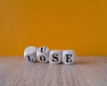 Use or lose symbol. Concept words Use or lose on wooden cubes. Beautiful wooden table, orange background. Business Use or lose