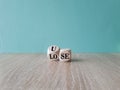 Use or lose symbol. Concept words Use or lose on wooden cubes. Beautiful wooden table blue background. Business Use or lose