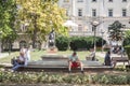 People from Belgrade watching together a smartphone in the streets of the Serbian capital city.