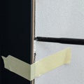 The use of painter`s tape in the installation of the door, the tape restrains the deformation of the door during the filling of
