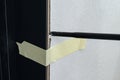 The use of painter& x27;s tape in the installation of the door, the tape restrains the deformation of the door during the