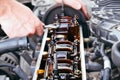 Car repair. The use of poor quality oil in the engine. Deposits of tar from oil on the inside of the engine. The mechanic examines