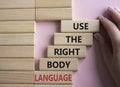 Use the righ Body Language symbol. Concept words Use the righ Body Language on wooden blocks. Businessman hand. Beautiful pink