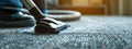 Use a vacuum cleaner to clean the carpet. Selective focus. Royalty Free Stock Photo