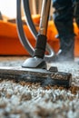 Use a vacuum cleaner to clean the carpet. Selective focus. Royalty Free Stock Photo