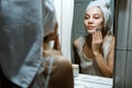 Use Wash Off Face Mask, Using Peel-Off Mask Correctly. Young woman in towel on her head wash face after removing mask in