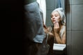 Use Wash Off Face Mask, Using Peel-Off Mask Correctly. Young woman in towel on her head wash face after removing mask in Royalty Free Stock Photo