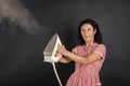 use it well. retro maid holding modern iron. housework is fun. Retro woman ironing clothes. Housekeeper in retro dress Royalty Free Stock Photo