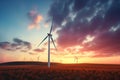 Use of wind turbines to produce environmentally friendly renewable energy electricity at sunset Royalty Free Stock Photo