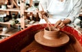 Use your hands to make magic. an unrecognizable woman molding clay on a pottery wheel. Royalty Free Stock Photo