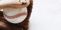 Used baseball in brown glove closeup