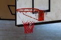 Used basketball backboard, hoop, net inside of basketball court, Right side view, close up Royalty Free Stock Photo