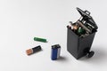 Used batteries in the garbage container on white background. Electronic waste concept. Eco-friendly disposal Royalty Free Stock Photo