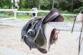 Used black dressage horse riding saddle with girth, stirrup and riding gloves