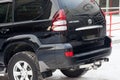 Used black Toyota Land Cruiser Prado 2007 release with an engine of 4 liters rear view on the car snow parking after preparing for
