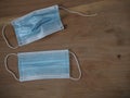 Used and broken 3-ply blue surgical mask to cover the mouth and nose with rubber ear straps. Protection mask from bacteria and