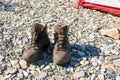 Used brown tracking boots on ground near the tent. comfortable, right shoes for tourism, climbing, hiking