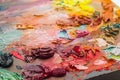 used brushes in an artist's palette of colorful oil paint for dr Royalty Free Stock Photo