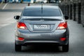 Used budget korean car b class in gray color, back view sedan