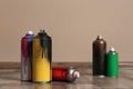 Used cans of spray paint on floor indoors. Royalty Free Stock Photo