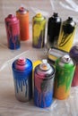 Used cans of spray paints on floor. Graffiti supplies Royalty Free Stock Photo