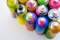 Used cans of spray paints on white background, above view. Graffiti supplies Royalty Free Stock Photo